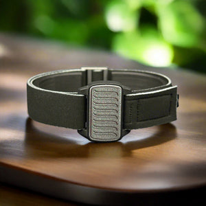 Dexband CGM armband for FDexcom G6 and ONE+ with pewter wave cover and water-resistant neoprene strap on wooden tabletop.