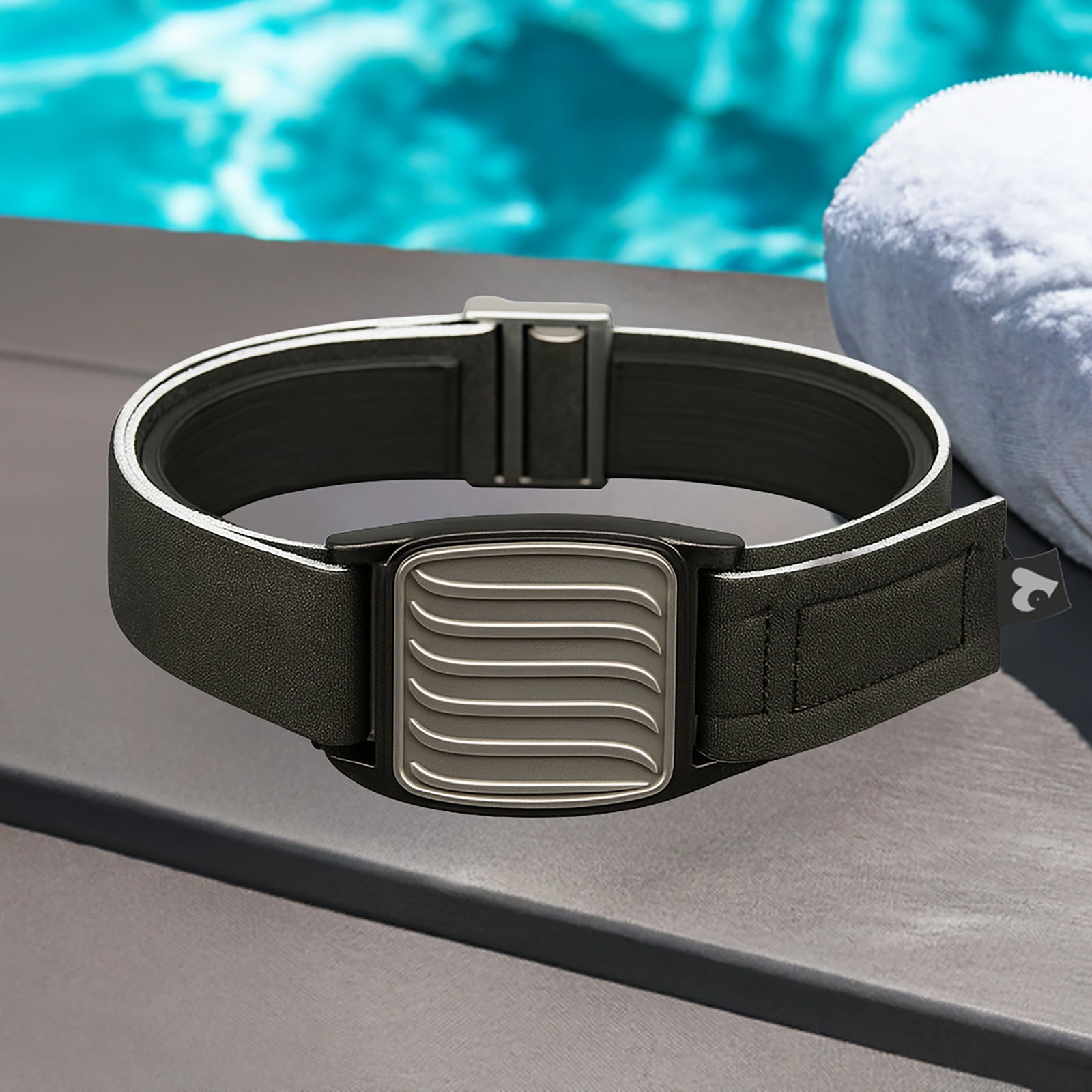 Dexband CGM pewter wave armband with black neoprene strap, compatible with Dexcom G7 and ONE+ sensors, in swimming pool setting.