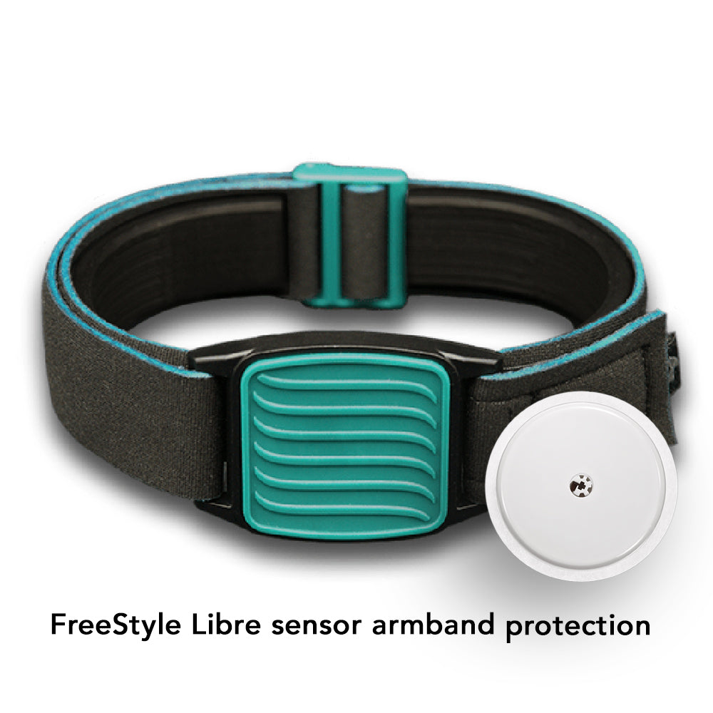 Libreband in teal with wave design on cover for Freestyle Libre sensor. Towel and swimming pool background.