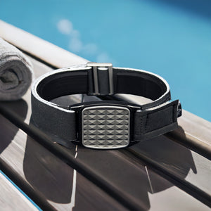 Libreband CGM armband for FreeStyle Libre 2 with pewter pyramids cover and water-resistant neoprene strap on wooden lounger in swimming pool setting. LML4634, LML2906, LML2616, LML2623.