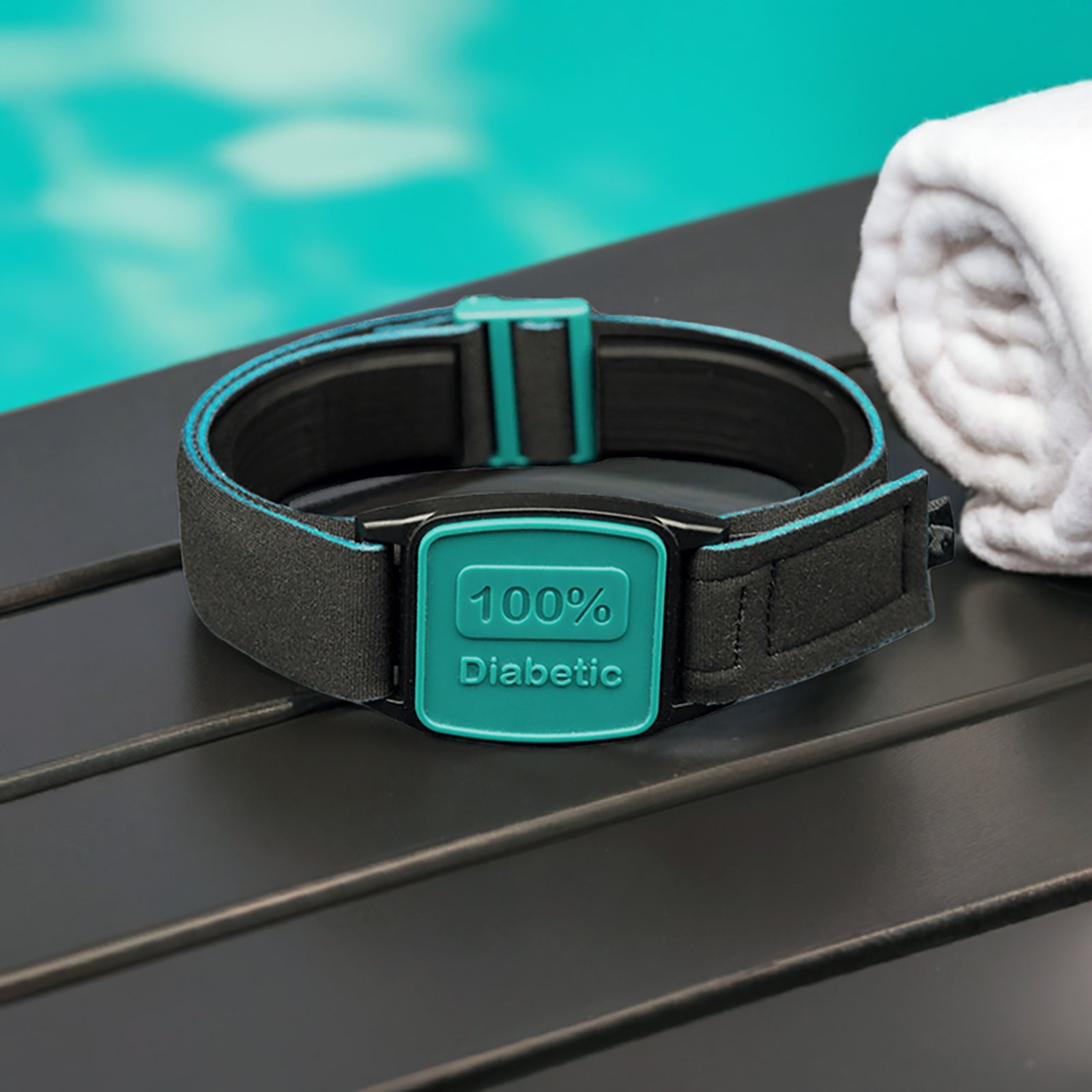 Libreband CGM armband for FreeStyle Libre 2 with teal 100% Diabetic cover and water-resistant neoprene strap on wooden lounger in swimming pool setting. LML4672, LML3033, LML2395, LML2401.