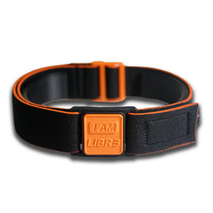 Close-up of Libreband CGM armband for FreeStyle Libre 3 with orange I AM LIBR3 cover and water-resistant neoprene strap, for everyday wear, sport and swimming.. LML4764, LML4399, LML4382, LML4375.