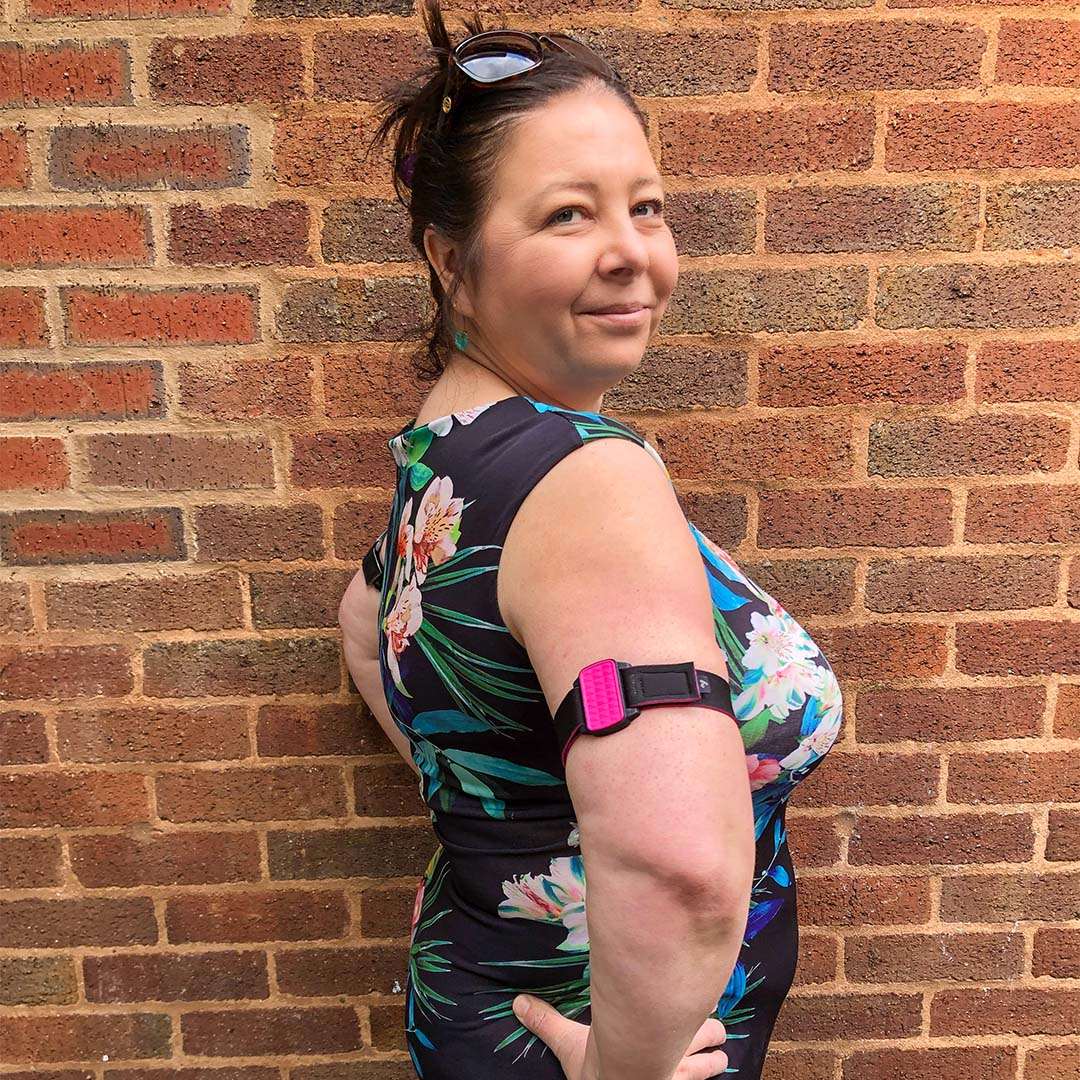 Dexband for Dexcom G6 CGM with wave style magenta cover and black neoprene strap.