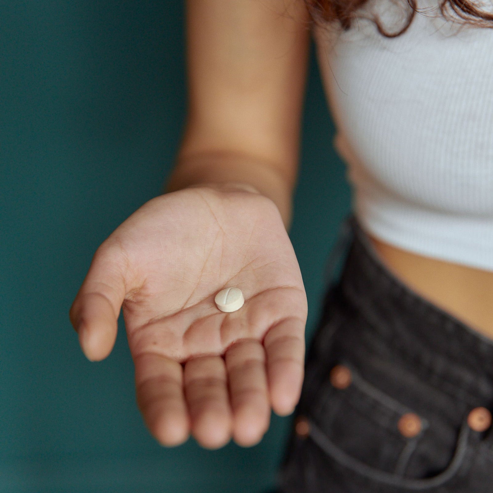 Woman holding metformin pill for type 2 diabetes treatment