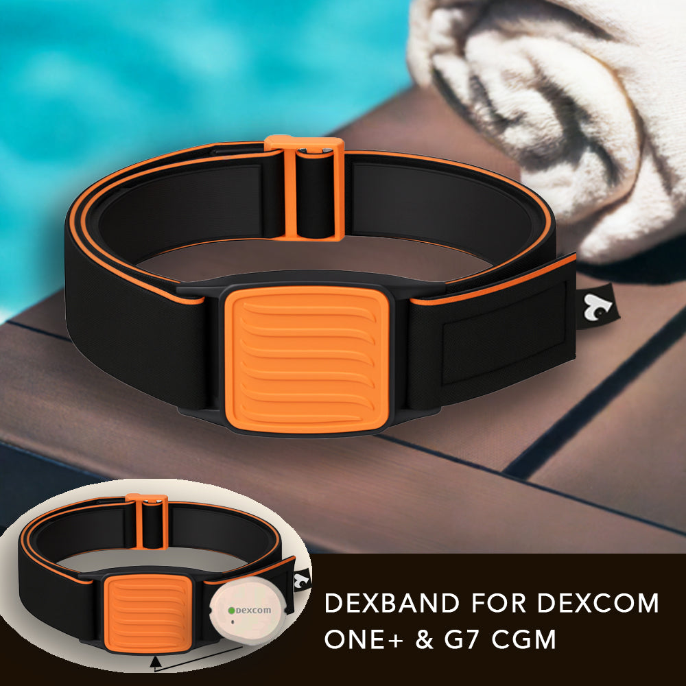 Dexband Armband for Dexcom G7, black strap with orange wave design cover.  Shown next to towel with swimming pool in background.