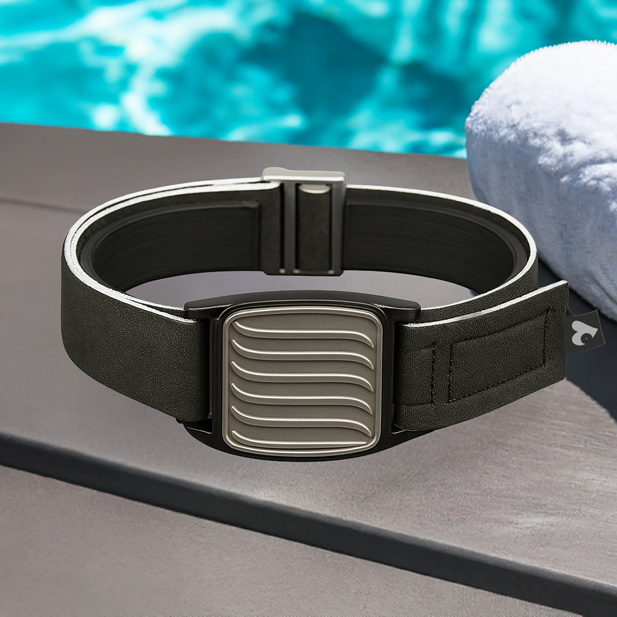 Dexband CGM pewter wave armband with black neoprene strap, compatible with Dexcom G7 and ONE+ sensors, in swimming pool setting.