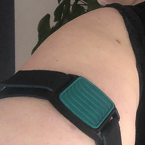 Dexband CGM armband for Dexcom G7 and ONE+ sensors with teal wave cover and neoprene strap worn on upper arm. LML3927, LML3934, LML3941, LML5051.