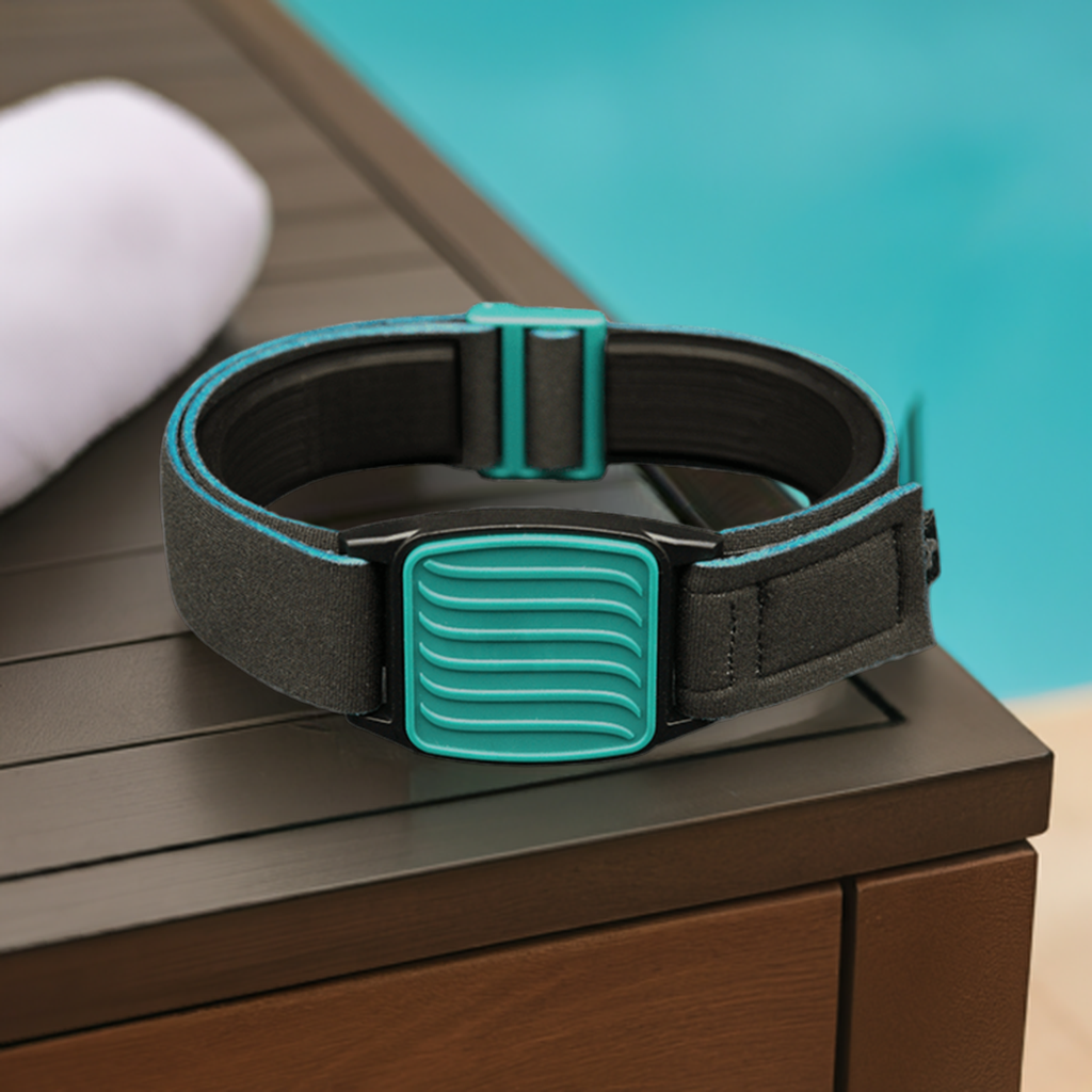 Libreband in teal with wave design on cover for Freestyle Libre sensor. Towel and swimming pool background.