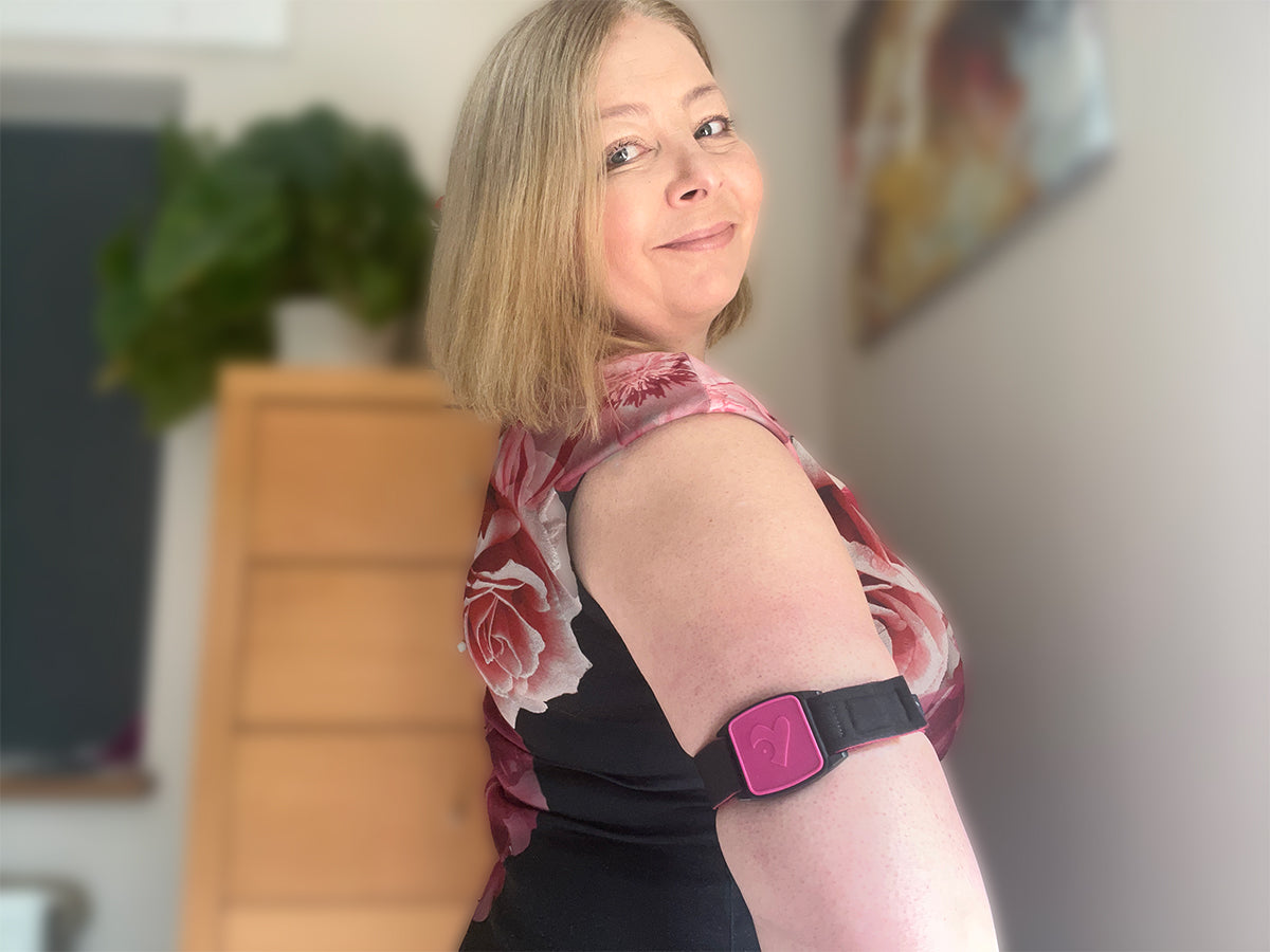 Libreband Armband for Freestyle Libre 1 &amp; 2. Magenta cover with Heart design. Shown with model wearing armband.
