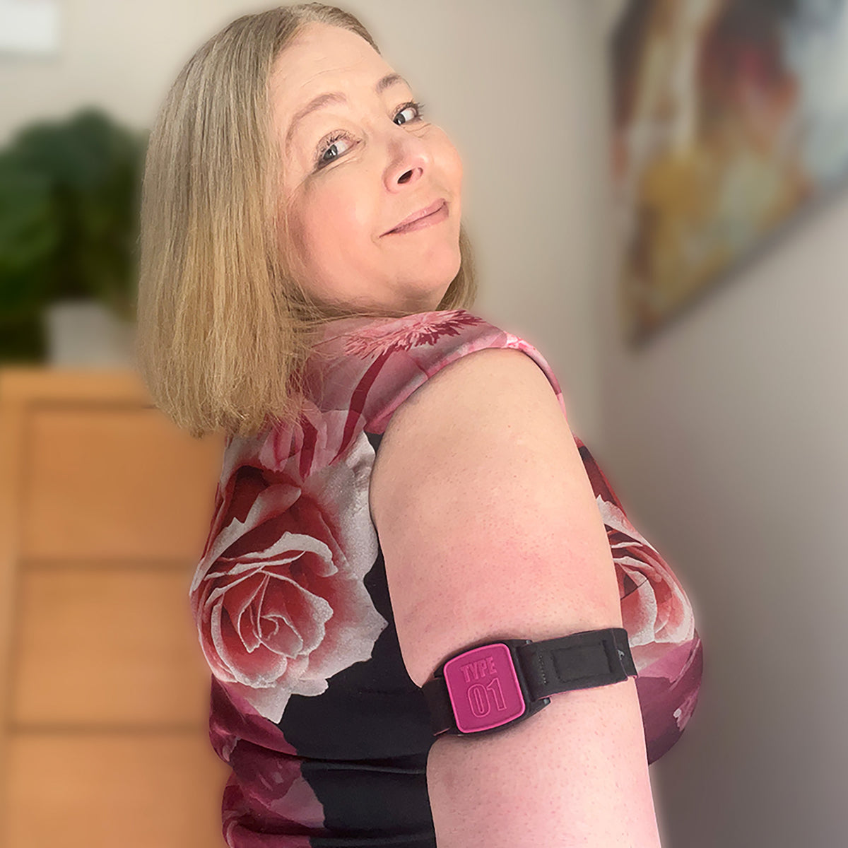 Libreband CGM armband for FreeStyle Libre 2 with magenta Type 01 cover and water-resistant neoprene strap worn on upper arm to help reduce risk of sensor being knocked off. LML2326, LML2319, LML3002, LML4504.