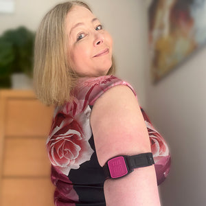 Libreband CGM armband for FreeStyle Libre 2 with magenta Type 01 cover and water-resistant neoprene strap worn on upper arm to help reduce risk of sensor being knocked off. LML2326, LML2319, LML3002, LML4504.