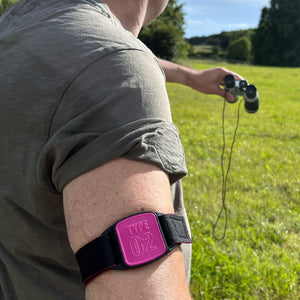 CGM armband for FreeStyle Libre 2 with magenta Type 02 cover and water-resistant neoprene strap worn on upper arm.