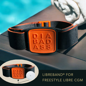 Libreband CGM armband for FreeStyle Libre 2 with orange Diabadass cover and water-resistant neoprene strap on wooden lounger in swimming pool setting.
