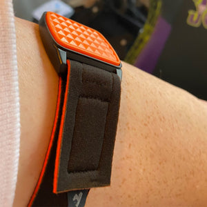 Libreband CGM armband for FreeStyle Libre 2 with orange pyramids cover and water-resistant neoprene strap worn on upper arm. LML4566, LML2890, LML2838, LML2845.