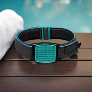 Libreband CGM armband for FreeStyle Libre 2 with teal pyramids cover and water-resistant neoprene strap on wooden lounger in swimming pool setting