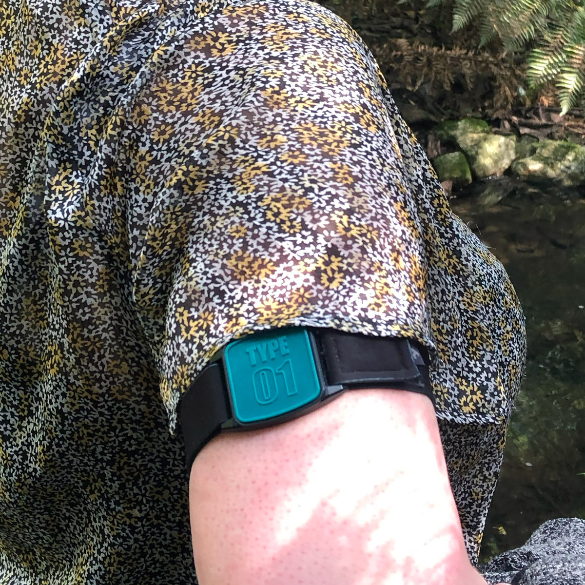 Libreband CGM armband for FreeStyle Libre 2 with teal Type 01 cover and water-resistant neoprene strap worn on upper arm to help reduce risk of sensor being knocked or falling off. LML4719, LML2999, LML2418, LML2425.