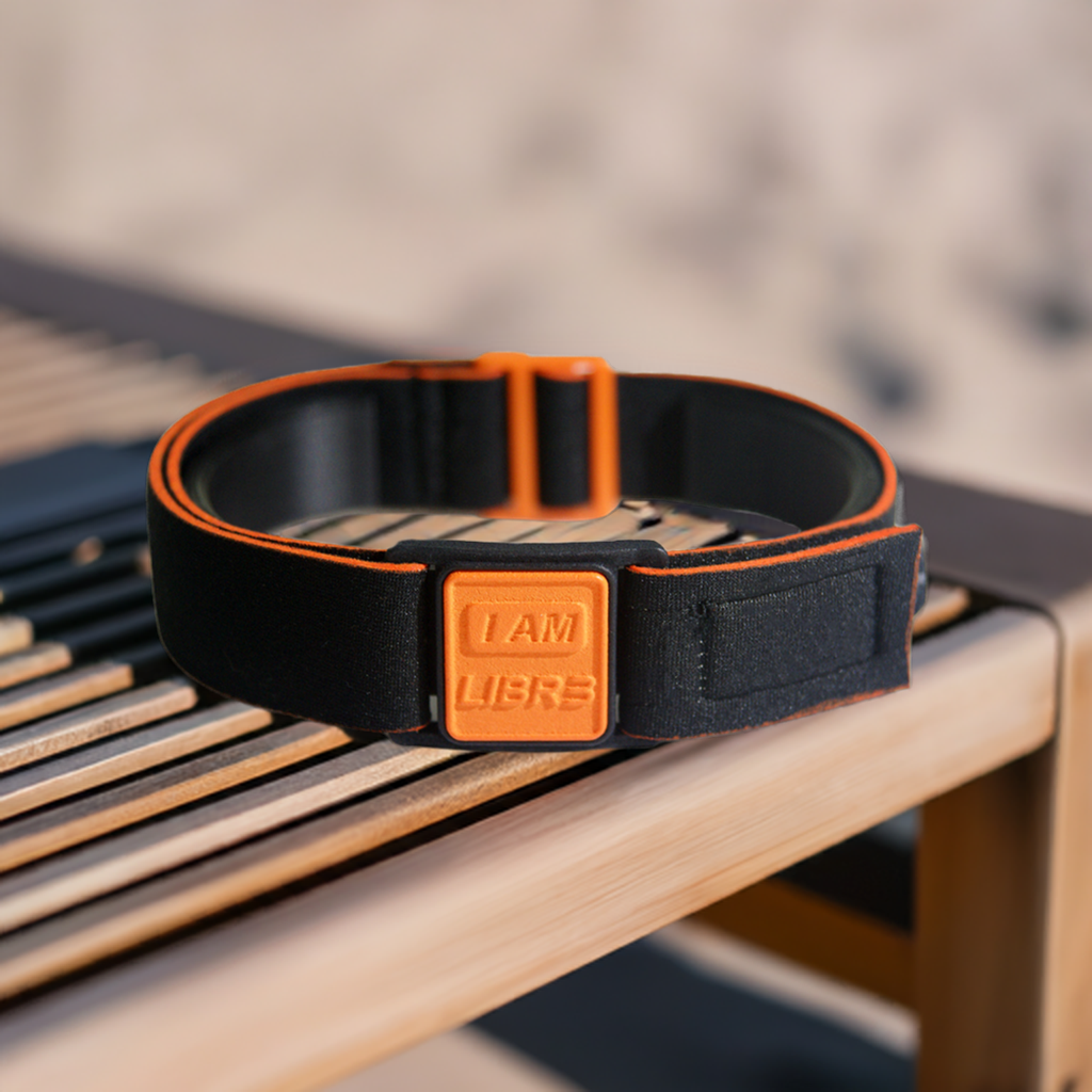 Libreband CGM armband for FreeStyle Libre 3 with orange I AM LIBR3 cover and water-resistant neoprene strap on beach lounger for swimming and holidays