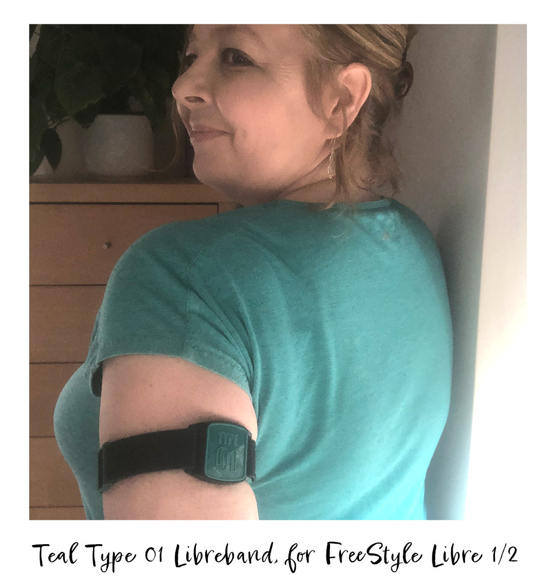 Libreband armband with teal Type 01 design worn on upper arm.